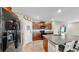 Contemporary kitchen with a center island, granite counters, dark wood cabinets, and eat-in seating at 17102 Yellow Pine St, Wimauma, FL 33598