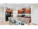 Modern kitchen featuring granite countertops, an island with seating, and stainless steel appliances at 17102 Yellow Pine St, Wimauma, FL 33598