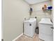 Well-organized laundry room with washer, dryer, and shelving for convenient storage at 17102 Yellow Pine St, Wimauma, FL 33598