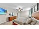 Bright main bedroom with dresser, modern decor, light-colored walls, and a ceiling fan at 17102 Yellow Pine St, Wimauma, FL 33598