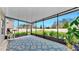 Enclosed patio with sliding windows and a lovely view of the green backyard at 17102 Yellow Pine St, Wimauma, FL 33598