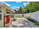 View of the backyard featuring a rock garden, a bench, a water conservation system, and white fencing at 1742 Mississippi Ne Ave, St Petersburg, FL 33703