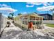 View of the backyard with a patio, and water conservation system, surrounded by white fencing at 1742 Mississippi Ne Ave, St Petersburg, FL 33703