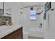 Clean bathroom with a shower-tub combo, a dark wood vanity, and plenty of natural light at 1742 Mississippi Ne Ave, St Petersburg, FL 33703