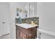 Bathroom featuring updated tile backsplash, neutral countertop, and ample lighting at 1742 Mississippi Ne Ave, St Petersburg, FL 33703