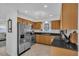 Well-lit kitchen features stainless steel appliances, granite countertops, and ample cabinet space and a view to the backyard at 1742 Mississippi Ne Ave, St Petersburg, FL 33703
