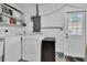 Well-lit laundry room with washer, dryer, storage shelves, and exterior door at 1742 Mississippi Ne Ave, St Petersburg, FL 33703