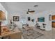 Inviting living room boasts tile flooring, ceiling fan, bright natural light, comfortable seating and tasteful decor at 1742 Mississippi Ne Ave, St Petersburg, FL 33703