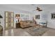 Bright living room featuring neutral paint, large windows, ceiling fan, tile floors, and comfortable seating arrangement at 1742 Mississippi Ne Ave, St Petersburg, FL 33703
