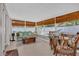This sunroom offers comfortable seating, a glass top table, and many windows for bright natural light at 1742 Mississippi Ne Ave, St Petersburg, FL 33703