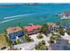 Waterfront home boasts stunning views, lush landscaping, a private dock, and easy access to bay waters at 26 Sunset Bay Drive, Belleair, FL 33756