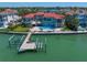 Waterfront home featuring a private dock, swimming pool, backyard area, and easy access to serene bay waters at 26 Sunset Bay Drive, Belleair, FL 33756