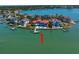 Stunning aerial view showcasing waterfront home with private dock and pool; surrounded by beautiful blue waters at 26 Sunset Bay Drive, Belleair, FL 33756
