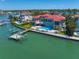 Waterfront property with private dock, pool, and lush landscaping, all overlooking serene bay waters at 26 Sunset Bay Drive, Belleair, FL 33756
