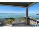 Stunning waterfront views from the balcony overlooking the pool and dock at 26 Sunset Bay Drive, Belleair, FL 33756