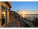 Balcony view overlooking the waterfront pool and waterfront, with a gorgeous sunset at 26 Sunset Bay Drive, Belleair, FL 33756