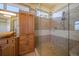 Well appointed tile shower and cabinetry complete a luxurious bathroom at 26 Sunset Bay Drive, Belleair, FL 33756