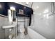 Bright primary bathroom with walk-in shower, soaking tub, pedestal sink, and stylish tile flooring at 26 Sunset Bay Drive, Belleair, FL 33756