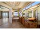 Luxurious bathroom with dual vanities, large windows, soaking tub and tranquil waterfront views at 26 Sunset Bay Drive, Belleair, FL 33756