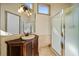 Bathroom featuring a glass shower and vanity with sink at 26 Sunset Bay Drive, Belleair, FL 33756