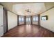Bright bedroom with hardwood flooring, large windows, French doors, and serene waterfront views at 26 Sunset Bay Drive, Belleair, FL 33756