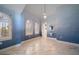 Light filled primary bedroom features bright blue accent wall, plantation shutters, and light hardwood flooring at 26 Sunset Bay Drive, Belleair, FL 33756
