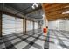 Spacious garage with a checkered floor and multiple doors, offering ample parking and storage space at 26 Sunset Bay Drive, Belleair, FL 33756