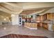 Open kitchen layout featuring custom cabinets, granite counters, and a breakfast bar at 26 Sunset Bay Drive, Belleair, FL 33756