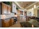 Gourmet kitchen boasts granite countertops, custom cabinetry, and stainless steel appliances at 26 Sunset Bay Drive, Belleair, FL 33756