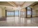 Expansive living room featuring water views, tray ceilings, and a decorative chandelier at 26 Sunset Bay Drive, Belleair, FL 33756