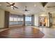 Bright and airy living room featuring water views, ceiling fans, and wood floors at 26 Sunset Bay Drive, Belleair, FL 33756