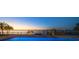 Inviting pool area with waterfront views and a private dock, ideal for luxurious outdoor living at 26 Sunset Bay Drive, Belleair, FL 33756