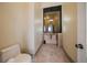 Well appointed powder room with a decorative vanity at 26 Sunset Bay Drive, Belleair, FL 33756