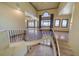 Elegant staircase with wrought iron railing and tile flooring leads to the main living areas at 26 Sunset Bay Drive, Belleair, FL 33756