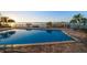 Outdoor swimming pool with a brick-paved deck, waterfront views, lounge chairs, and easy dock access at 26 Sunset Bay Drive, Belleair, FL 33756