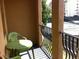 Cozy balcony with a small green table and chairs, overlooking community tennis courts at 501 Knights Run Ave # 2119, Tampa, FL 33602
