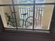 View of the balcony with a bike and a tennis court visible through the window at 501 Knights Run Ave # 2119, Tampa, FL 33602