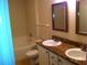 Well-lit bathroom with double vanity, granite countertop, and tub/shower combination, offering a functional space at 501 Knights Run Ave # 2119, Tampa, FL 33602