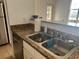 Kitchen sink and stainless steel dishwasher, with granite countertops and breakfast bar at 501 Knights Run Ave # 2119, Tampa, FL 33602