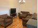 Cozy living room with hardwood floors and comfortable seating, great for relaxing and watching TV at 501 Knights Run Ave # 2119, Tampa, FL 33602