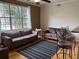Inviting living room with large window, neutral colors, ceiling fan, and comfortable seating arrangement with striped rug at 501 Knights Run Ave # 2119, Tampa, FL 33602
