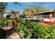 A brick pathway leading to a backyard with a pool, plants, and the home's exterior at 6226 Hampton N Ct, St Petersburg, FL 33710