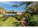 Well-maintained backyard featuring an above-ground pool, lush garden, and brick pathway at 6226 Hampton N Ct, St Petersburg, FL 33710