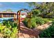 Landscaped backyard featuring a charming garden path, an above-ground pool, and lush foliage at 6226 Hampton N Ct, St Petersburg, FL 33710