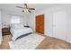 Cozy bedroom featuring a bed, nightstands, carpeted floors and ample closet space at 6226 Hampton N Ct, St Petersburg, FL 33710