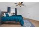 Comfortable bedroom with a wooden bed frame, blue bedding, and a ceiling fan at 6226 Hampton N Ct, St Petersburg, FL 33710