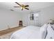 Bright bedroom featuring a ceiling fan, window with curtains, and a cozy chair at 6226 Hampton N Ct, St Petersburg, FL 33710