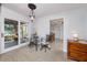 Dining area with a glass table, tile floors, sliding glass doors and views of the exterior at 6226 Hampton N Ct, St Petersburg, FL 33710