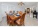 Charming dining room with a wooden table set for six and natural light at 6226 Hampton N Ct, St Petersburg, FL 33710
