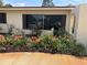 Charming home featuring a beautiful garden with vibrant flowers and a well-maintained lawn at 6226 Hampton N Ct, St Petersburg, FL 33710